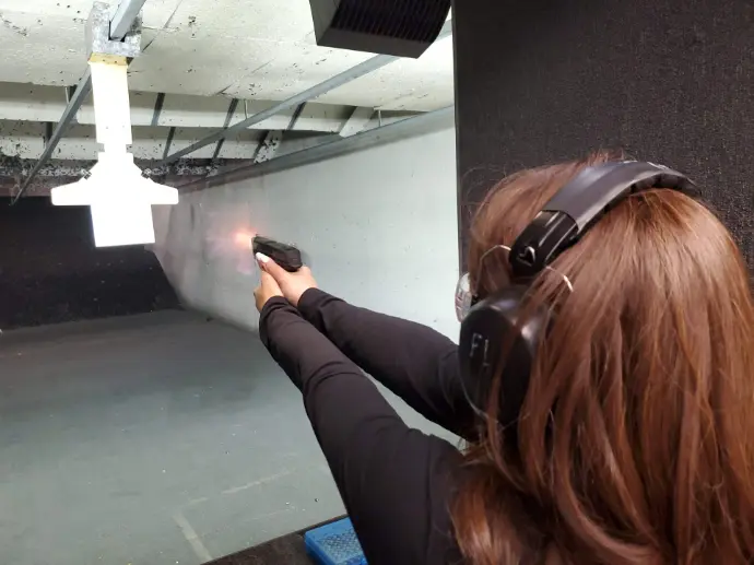 Woman shooting at pistol range